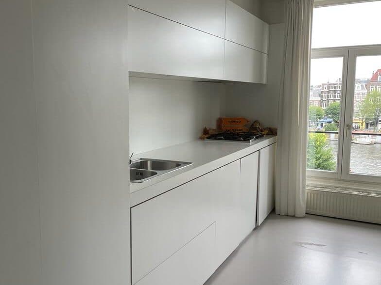 The kitchen before L7M: a plain white run of units along the wall